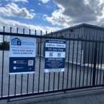 Facility gate with a poster fixed to the gate with facility information