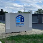 Large street sign with the West Main Storage logo